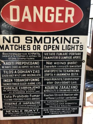 mine safety sign saying "Danger. No Smoking, matches or open lights" in many languages